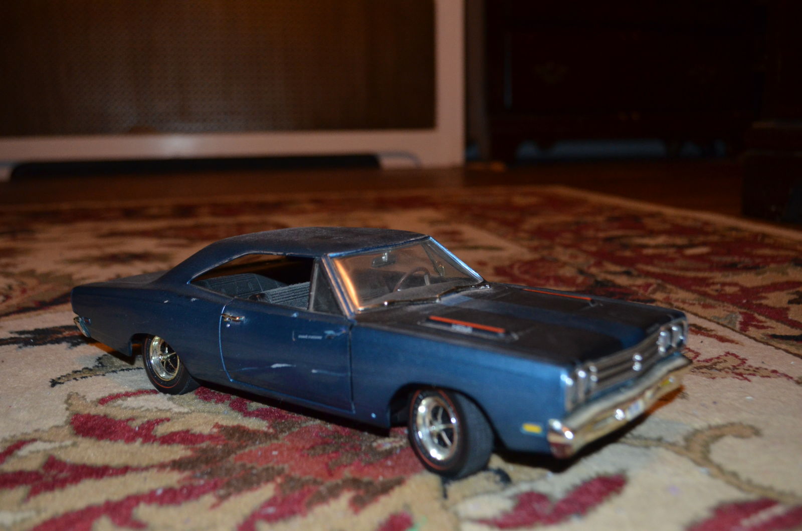  1/18 Plymouth Road Runner. Scuffs on passenger door, small touched up paint spot in black stripe on front of hood.  
