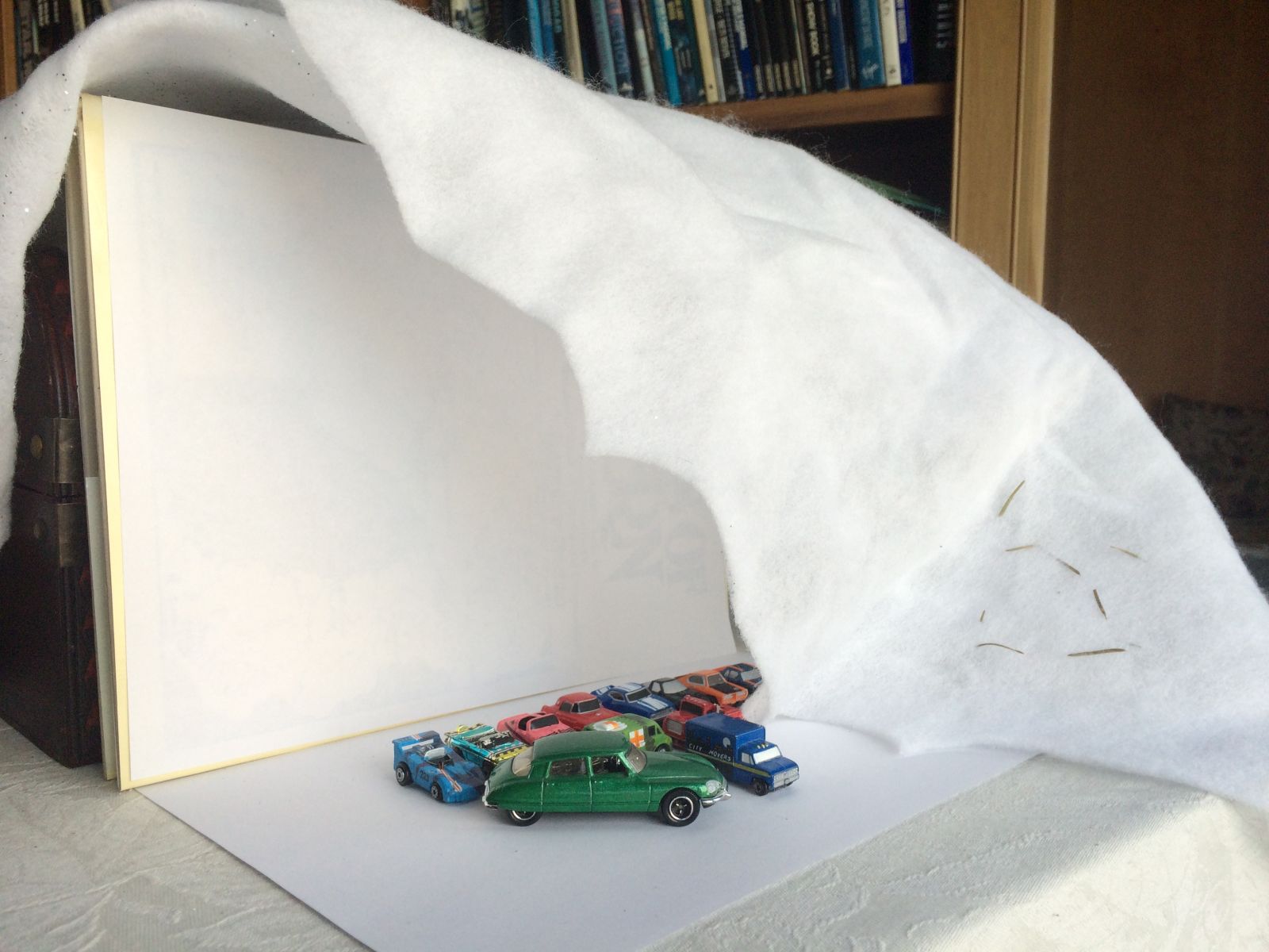 Here is my makeshift photo studio. Some paper, books, and a Christmas ‘snow’ blanket work pretty well together. 