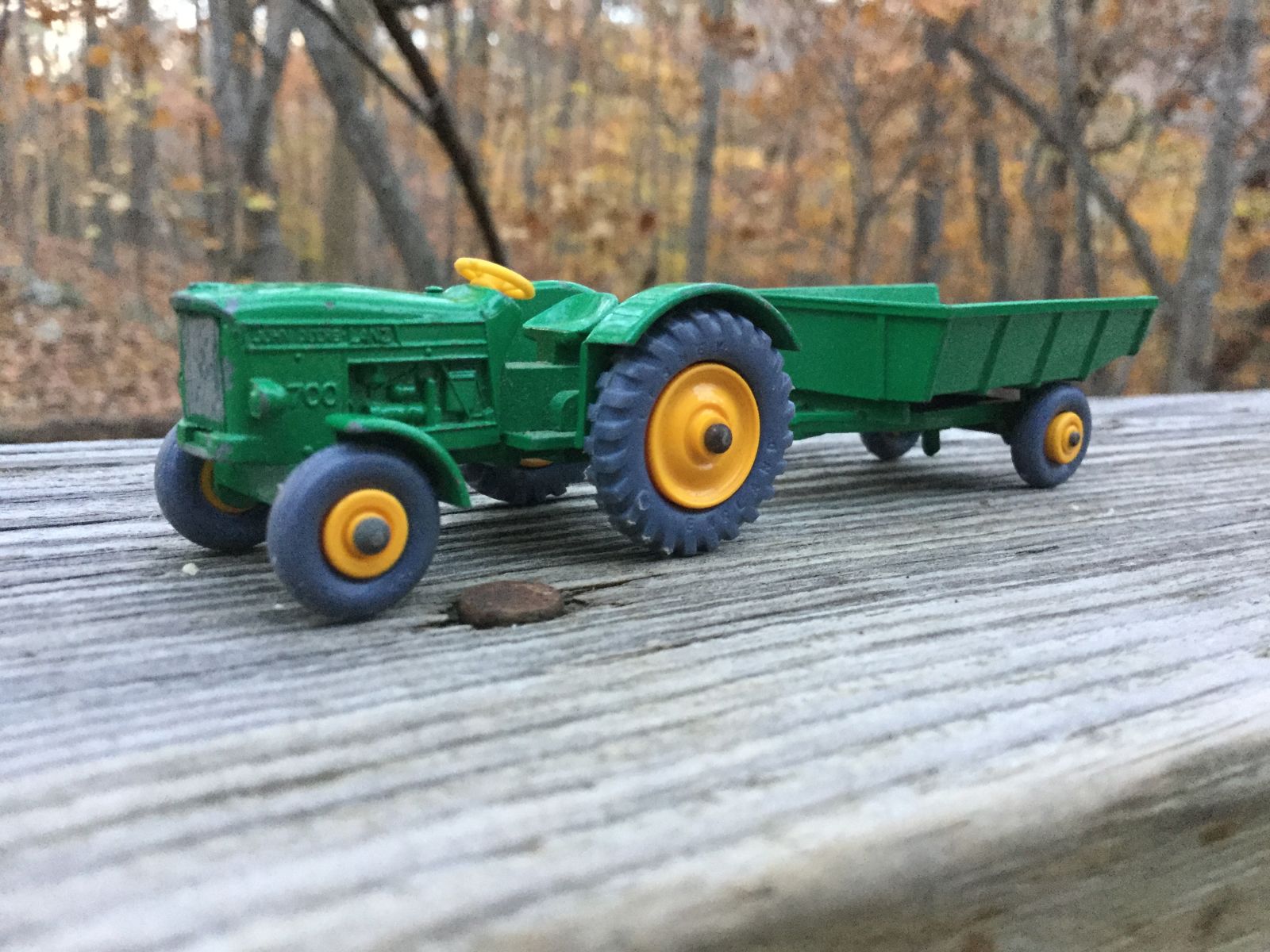 John Deere tractor and trailer. The trailer originally would have come with yellow barrels, but they’ gone MIA at some point in it’s 50 years of existence. This is a rarer “grey wheels” version.