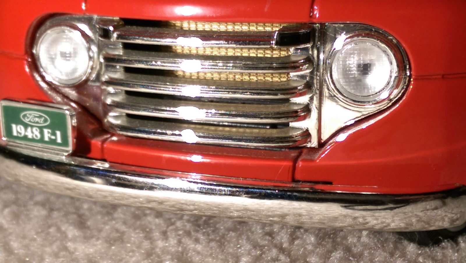 The grille isn’t a solid piece and you can see the brass radiator through the grille. 