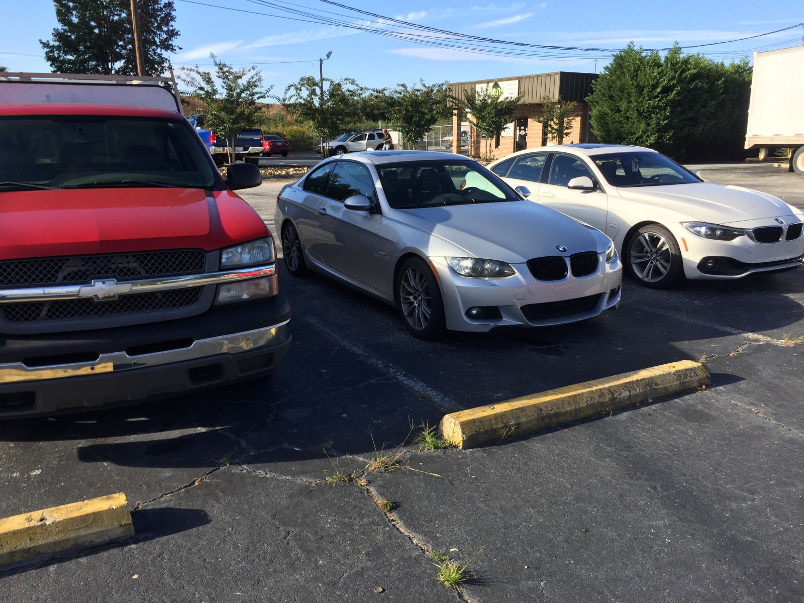 The work truck next to my E92 and another coworkers 4 series. 