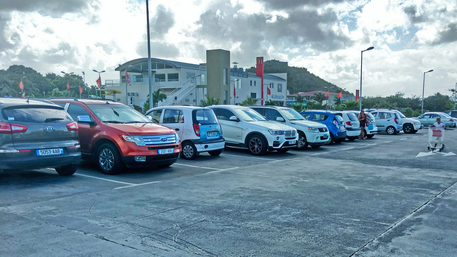 A pretty standard assortment of St. Martin cars at the Super U supermarket in Marigot