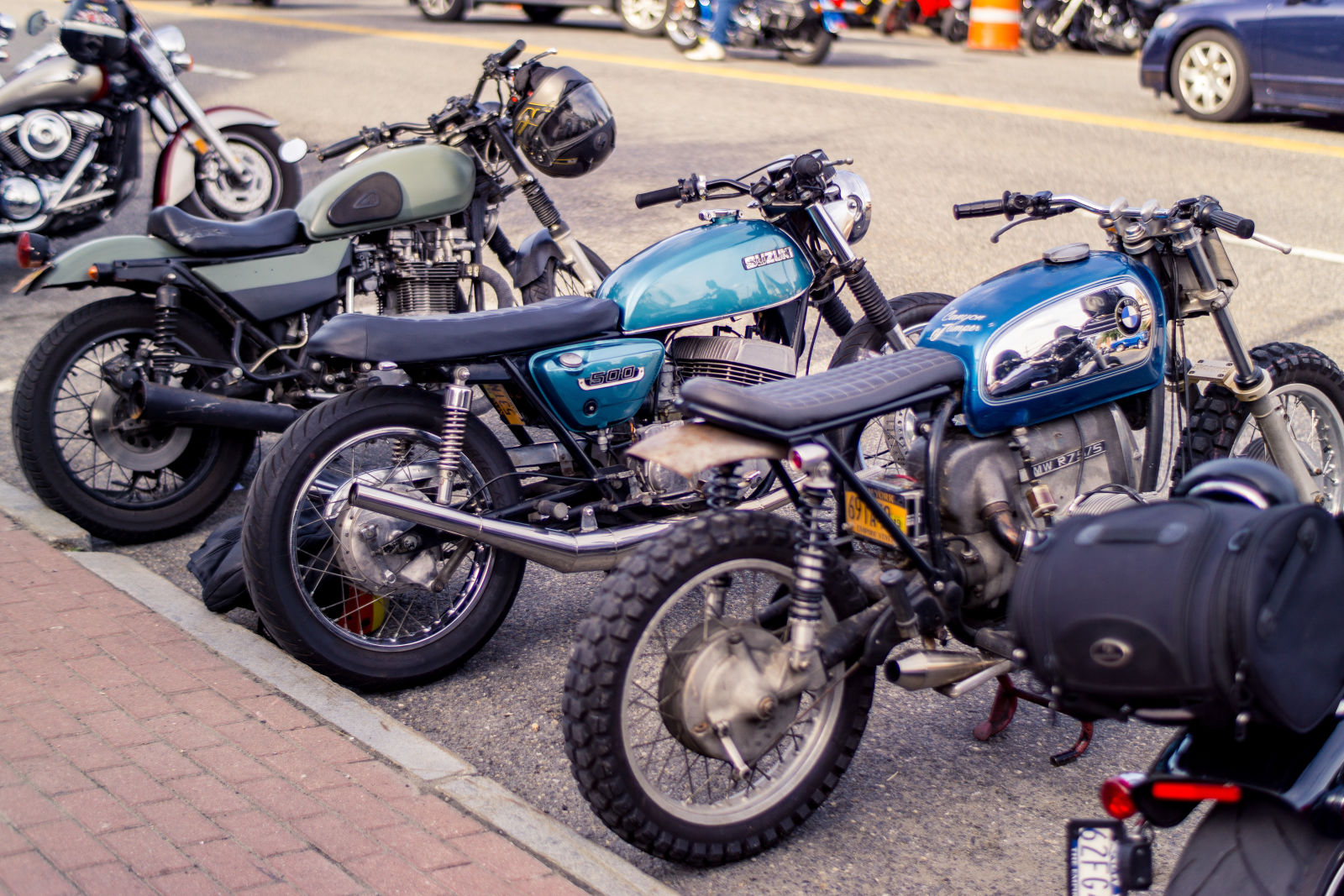 My hunk of junk kz750 twin (olive green) next to a couple of builds from a&amp;j cycle