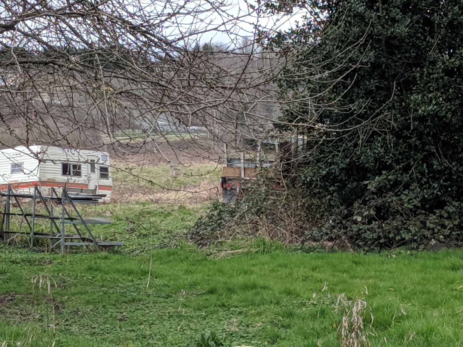 Camping trailer that looks like it hasn’t even been here for one season. And a commercial dump truck tucked away on the right.