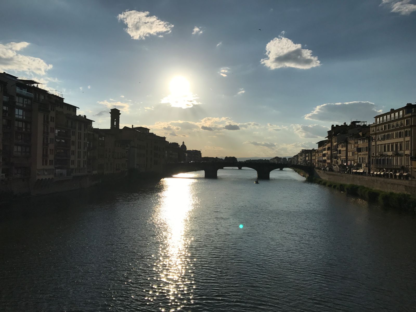 The Arno river flowing through the center of Florence at daybreak.