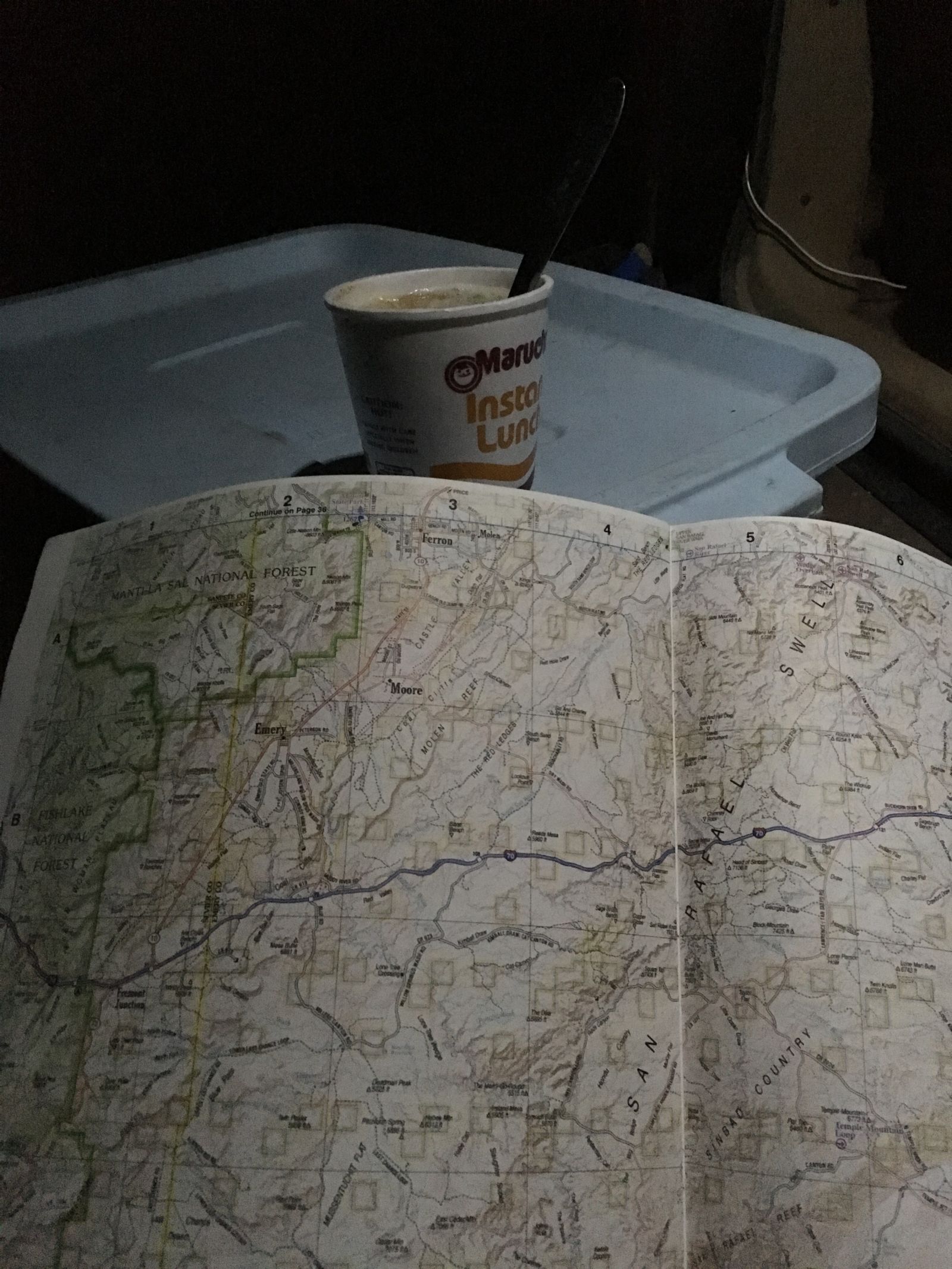 Enjoying a nutritious evening snack and plotting my fun in the warm glow of the LEDs on the hatch. Sometimes you need a big-format map to see the big picture. Always wanted to visit Sinbad Country.