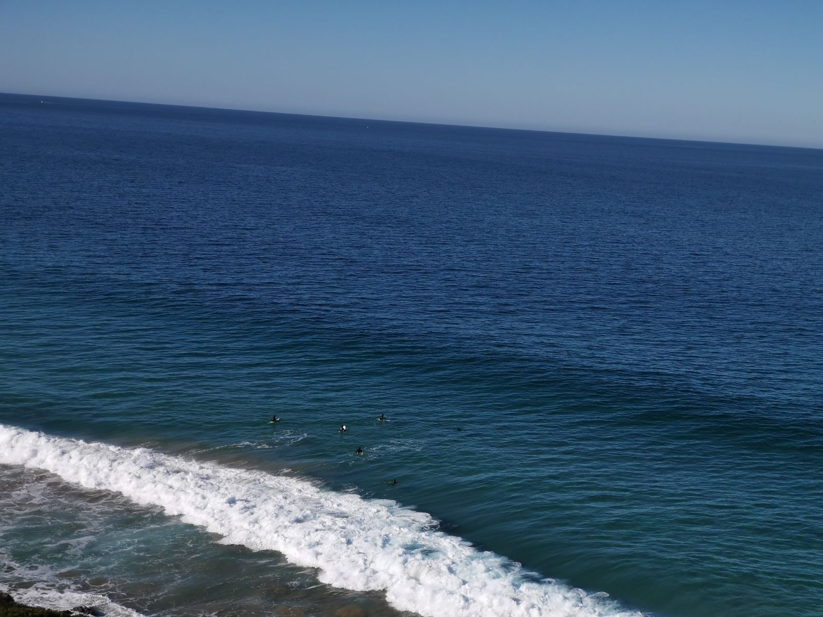 You can barely see the surfers. I only had my phone for pictures, you would have needed some serious photography gear to capture the dolphin. So you’ll just have to take my word for it.