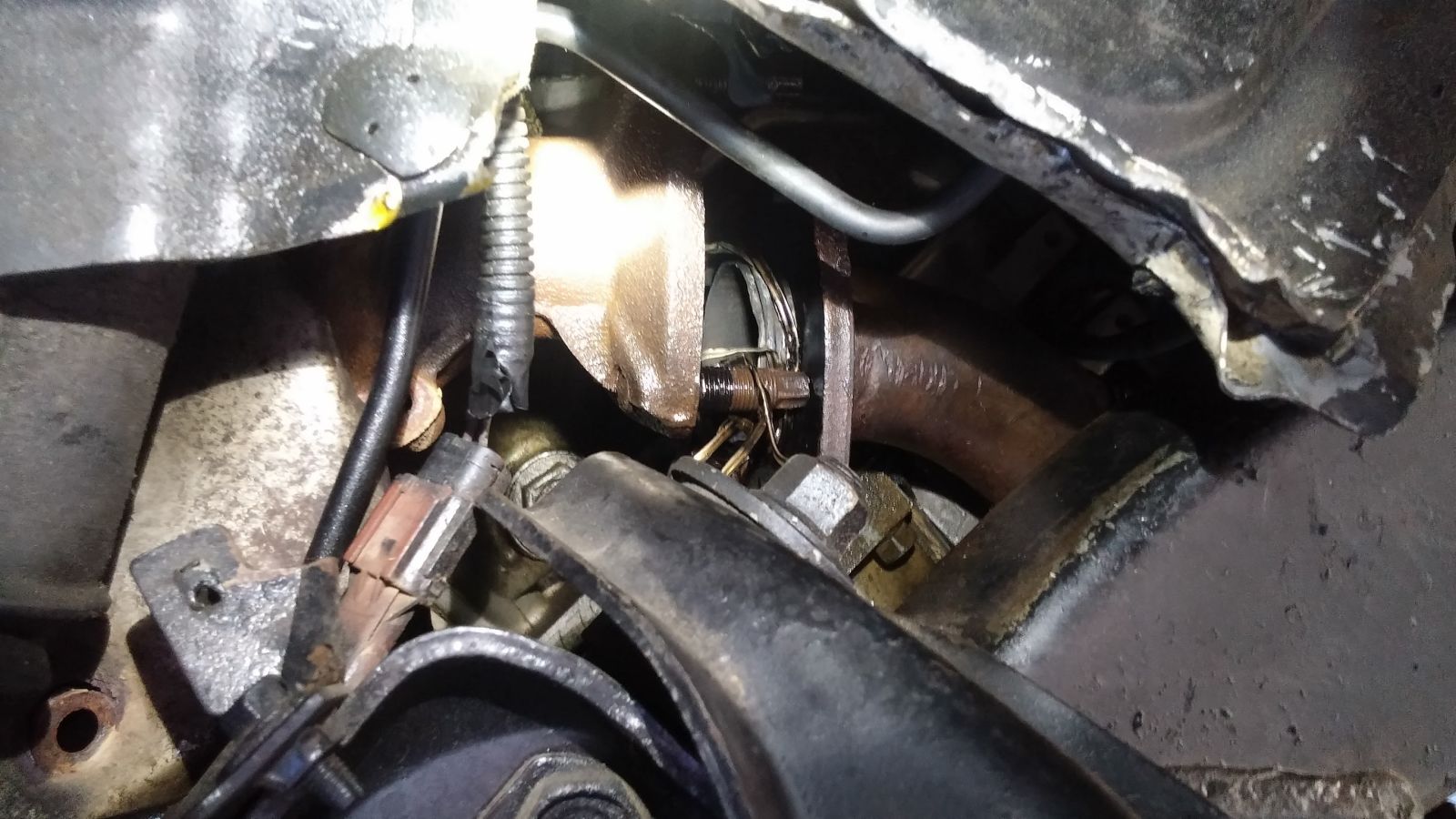 The previous owner had gasketed the exhaust using the wire from a bra.