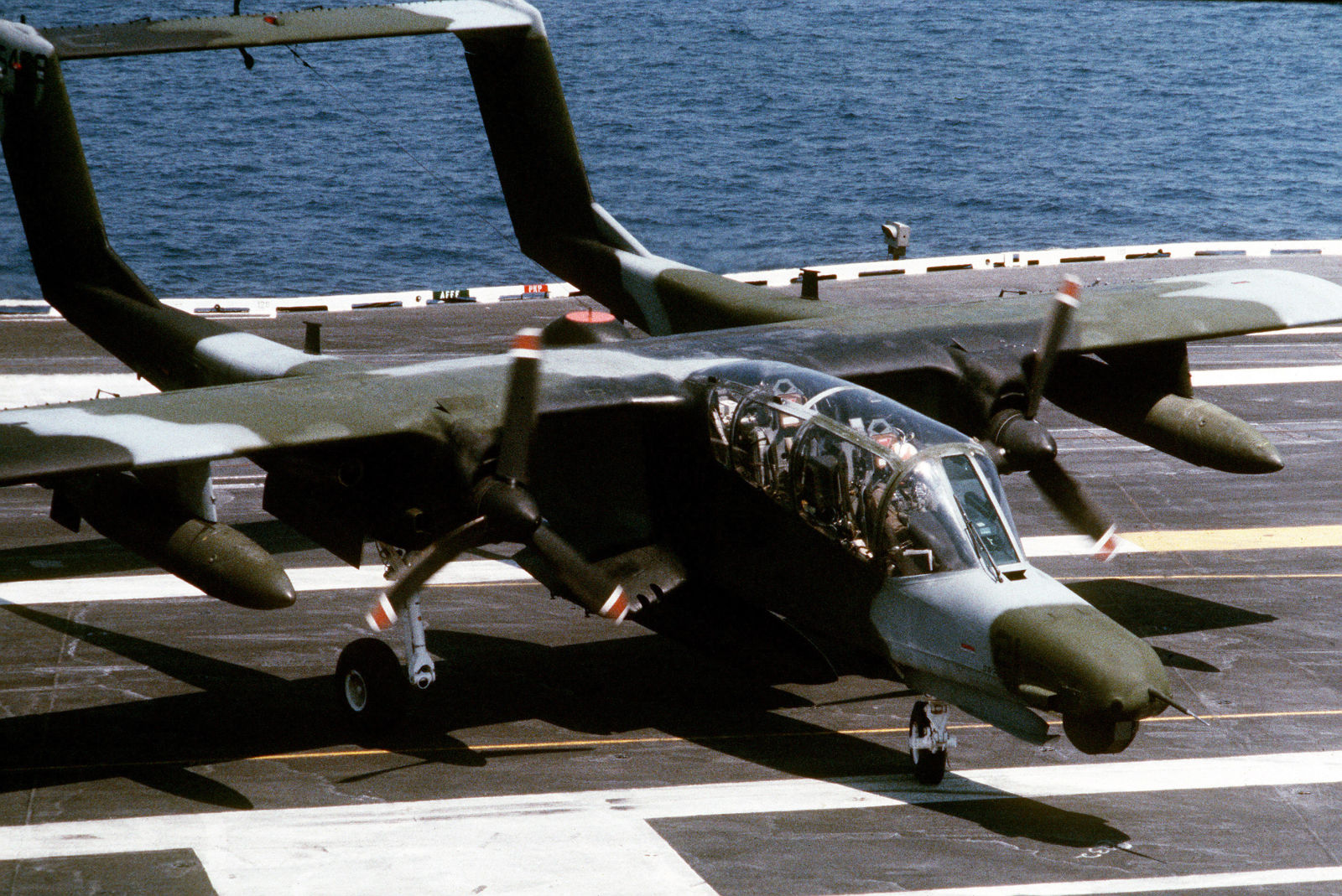 A USMC OV-10D taxing clear of the landing area on the carrier USS Saratoga in 1985