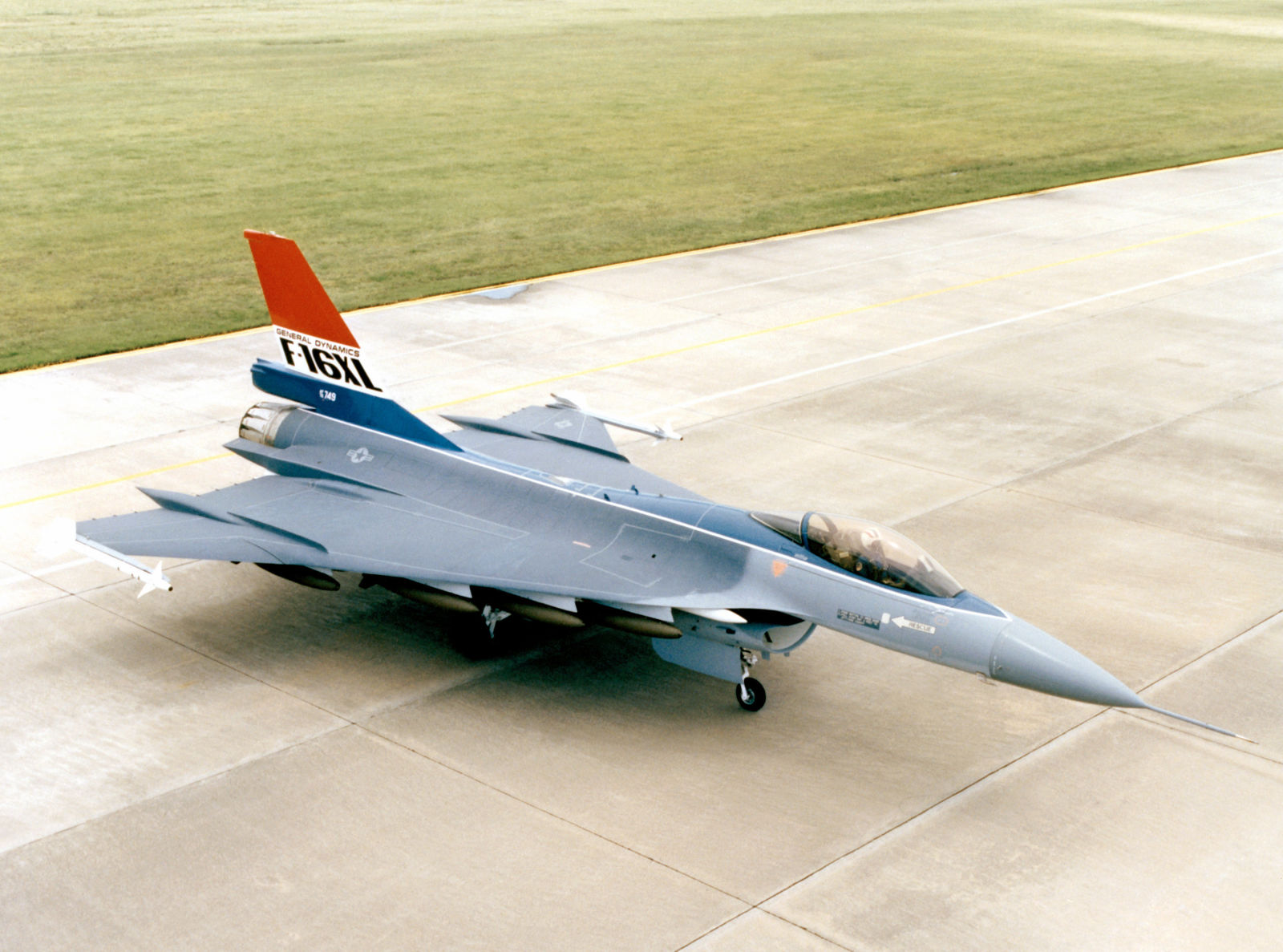 One of the F-16XL prototypes, painted in the early colors and armed with Sidewinders and bombs