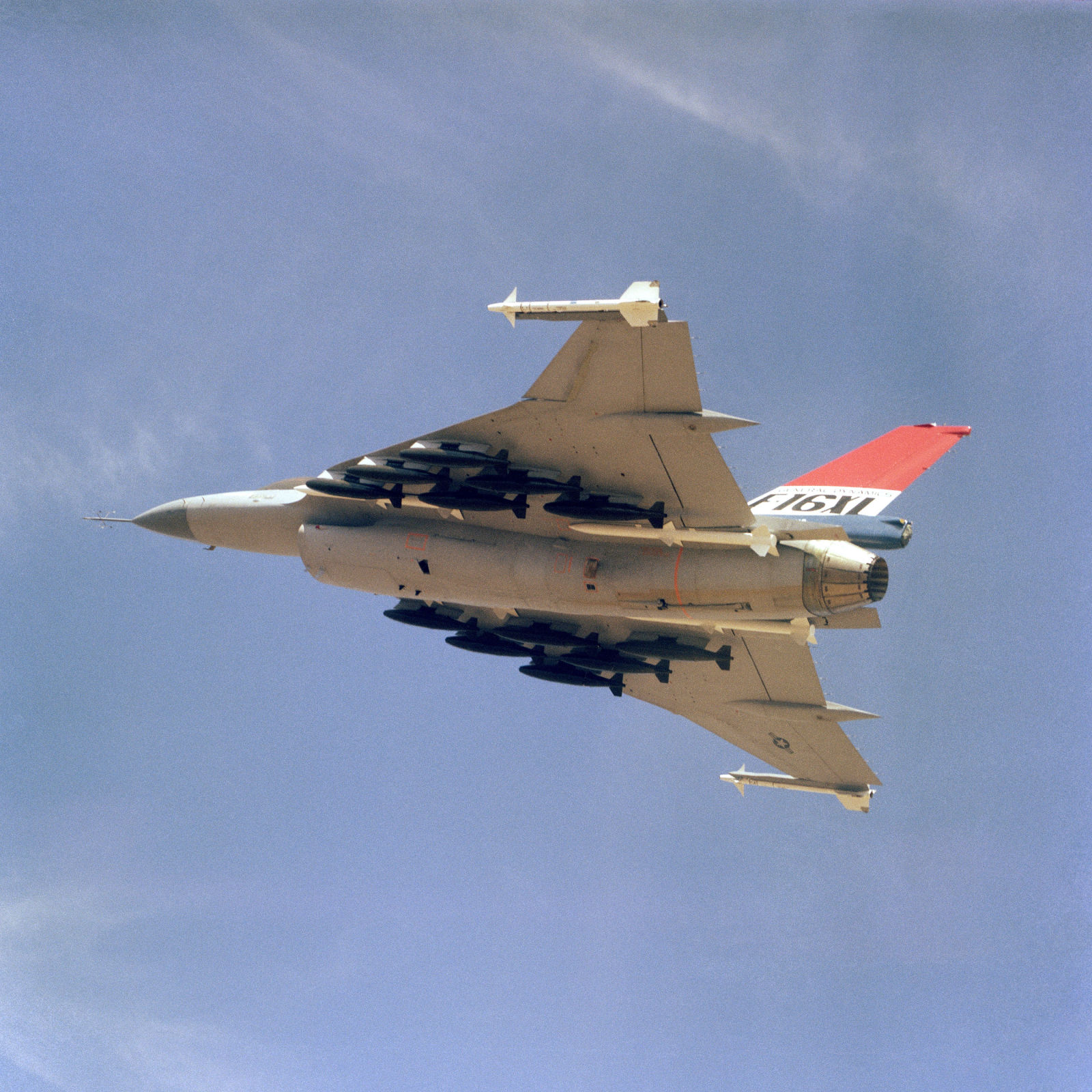 Air-to-air shot of an F-16XL on a demo flight. The XL is armed with two wing tip mounted AIM-9 Sidewinder and four fuselage mounted AIM-7 Sparrow missiles along with 12 500-pound bombs.