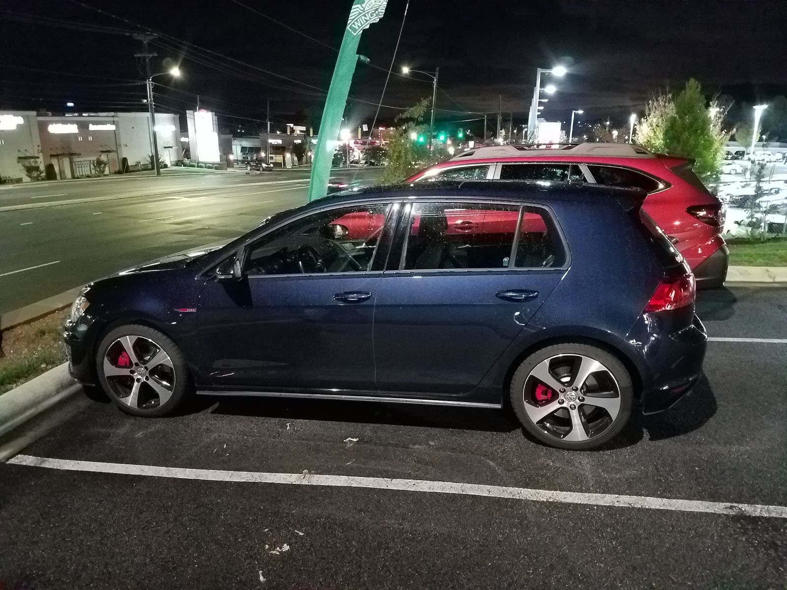 Parked next to my GTI on the night we bought it, photo taken because I was still surprised by the size, even though that is why I bought it.