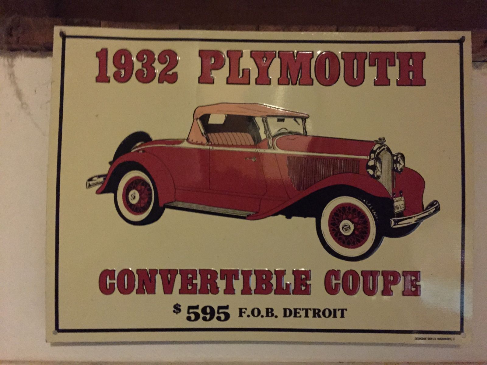 Tin advertisement hanging in the garage