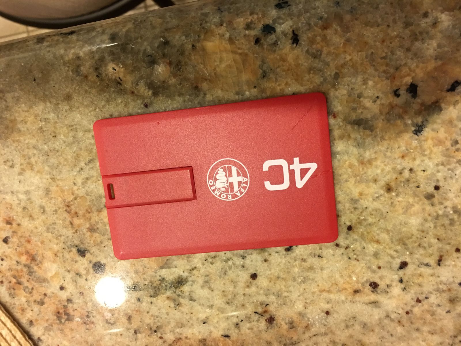 I found this stuck inside the inner cover. It took forever to pry out; the inner pouch had melted onto this plastic card. It took me several minutes to figure out that it rotates open and is actually a USB drive containing promotional videos.