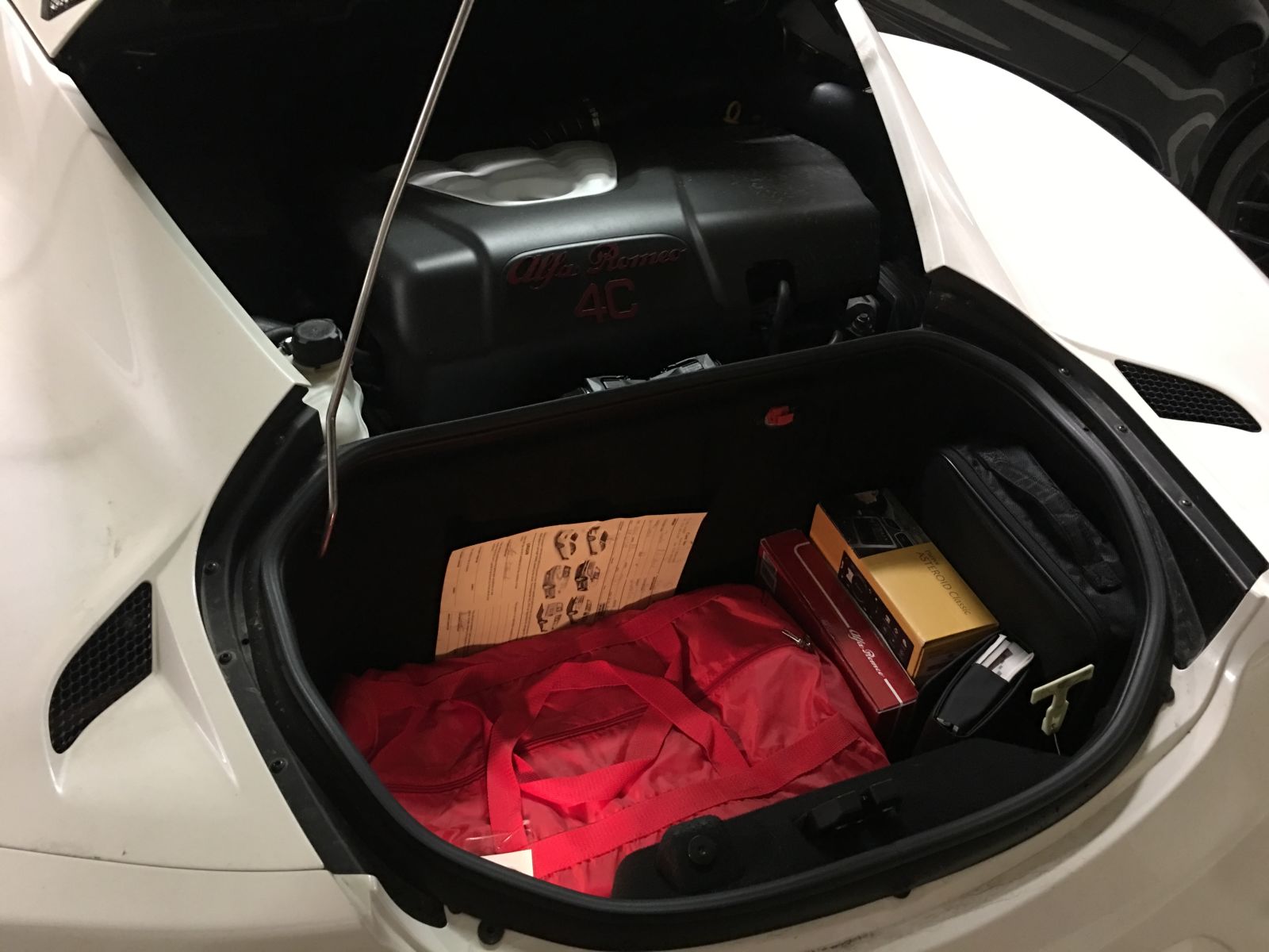 We all know the rear luggage boot is tiny, on the order of 3.5 cu ft. Here are all of the materials that came with the car when it was new. In the Spider version, this would be known as the roof storage bin because it wouldn’t be able to fit anything else.