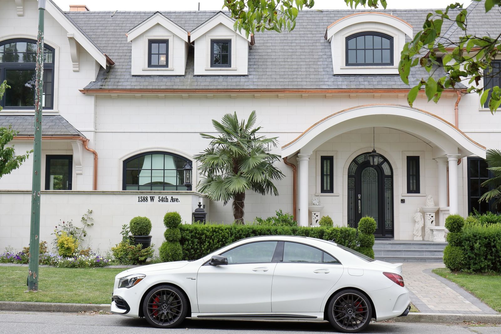 Normally a white Mercedes-AMG CLA 45 does not warrant a picture... there are probably more of them here than Toyota Camrys... the house it is parked in front of, though, is assessed by the city to be worth $11,483,000