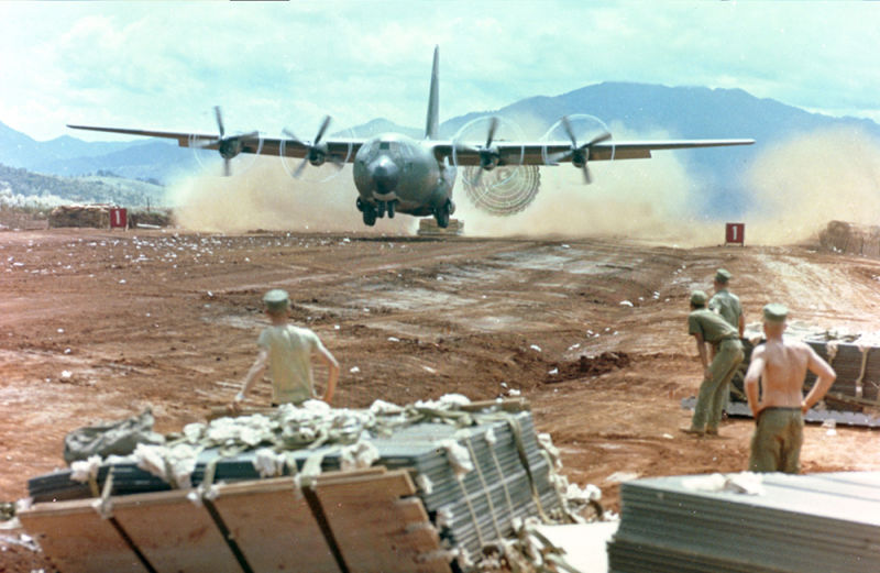 An Air Force C-130 performs a low altitude parachute extraction system (LAPES) delivery of supplies to an airbase in Vietnam (US Air Force)