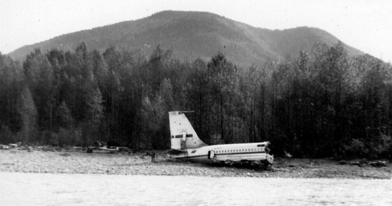 The tail section of Braniff 707 N7071 sits beside the Stillaguamish River. (Ron Palmer, Heraldnet)
