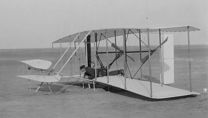 Wilbur Wright at the controls of the damaged Flyer after the first unsuccessful attempt at flight on December 14, 1903. (US Library of Congress)