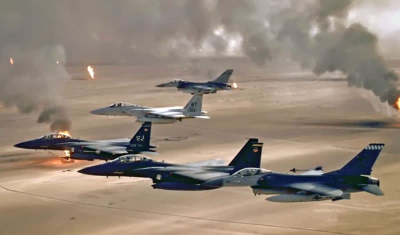 Two F-15E Strike Eagles, and F-15C Eagle, and two F-16 Fighting Falcons fly over the burning oil fields of Kuwait. (US Air Force)