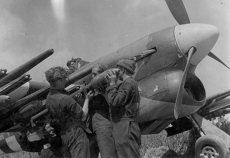 Members of the ground crew arm a Hawker Typhoon in preparation for Operation Overlord, the Allied invasion of France (UK Government)