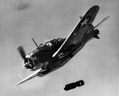 Dive flaps extended, a US Navy SBD Dauntless dives on its target and releases its bomb (US Navy)