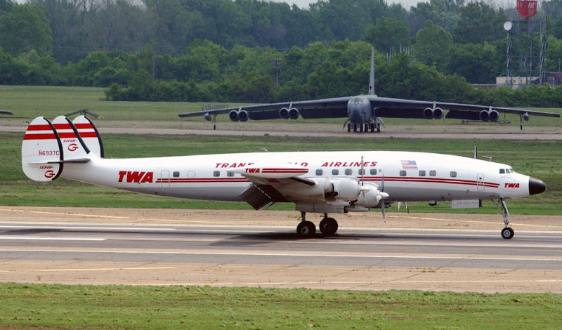 Lockheed L1049H Constellation (N6937C) painted in historic TWA livery taxis past a Boeing B-52H Stratofortress at Barksdale Air Force Base in 2004 (US Air Force)