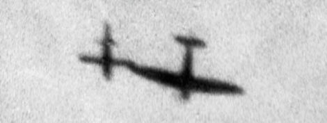 A Supermarine Spitfire uses its wing to tip over a V-1 in flight. (Imperial War Museum)