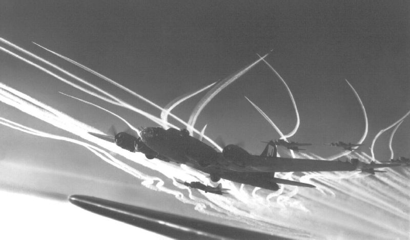 Boeing B-17F Flying Fortresses of the 390th Bomb Group, and their P-47 Thunderbolt escorts, leave vapor trails at high altitude over Europe in December 1943. (US Air Force)