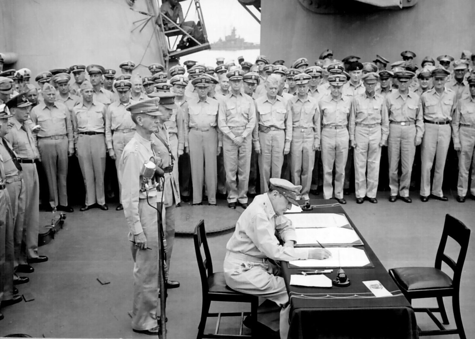 General of the Army Douglas MacArthur signs the Instrument of Surrender on behalf of the Allied Powers