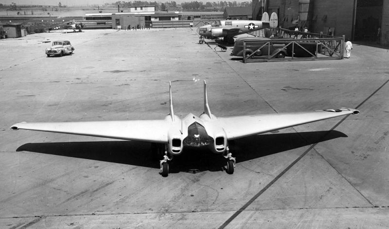 The intakes on the wingtips of the XP-79B supplied air to bellows that powered split-aileron controls. A Fairchild AT-21 Gunner is parked in the background. (US Air Force)