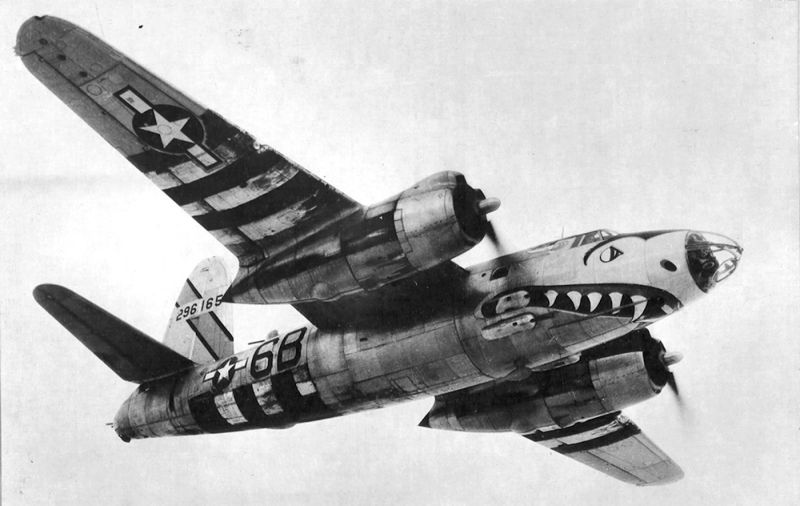 Battle-scarred B-26B Big Hairy Bird of the 599th bomber squadron, sporting a shark’s mouth and D-Day invasion stripes, flies somewhere over Europe in 1944. (US Air Force)
