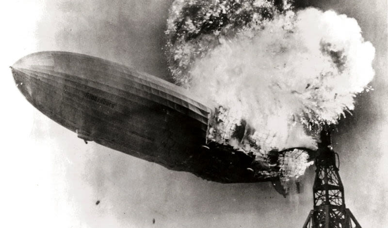 The German Zeppelin Hindenburg erupts into flames while attempting to land at Lakehurst, New Jersey (US Navy)