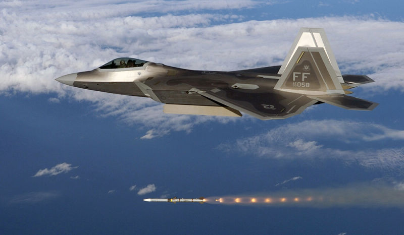 An F-22A Raptor 27th Fighter Squadron “Fighting Eagles” fires an AIM-120 Advanced Medium Range Air-to-Air Missile from its internal weapons bay