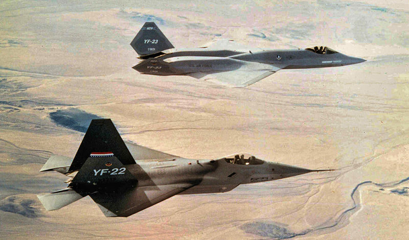 The YF-22 flies in formation with its Northrop YF-23 competitor. After a fly-off, the Air Force selected the YF-22. 